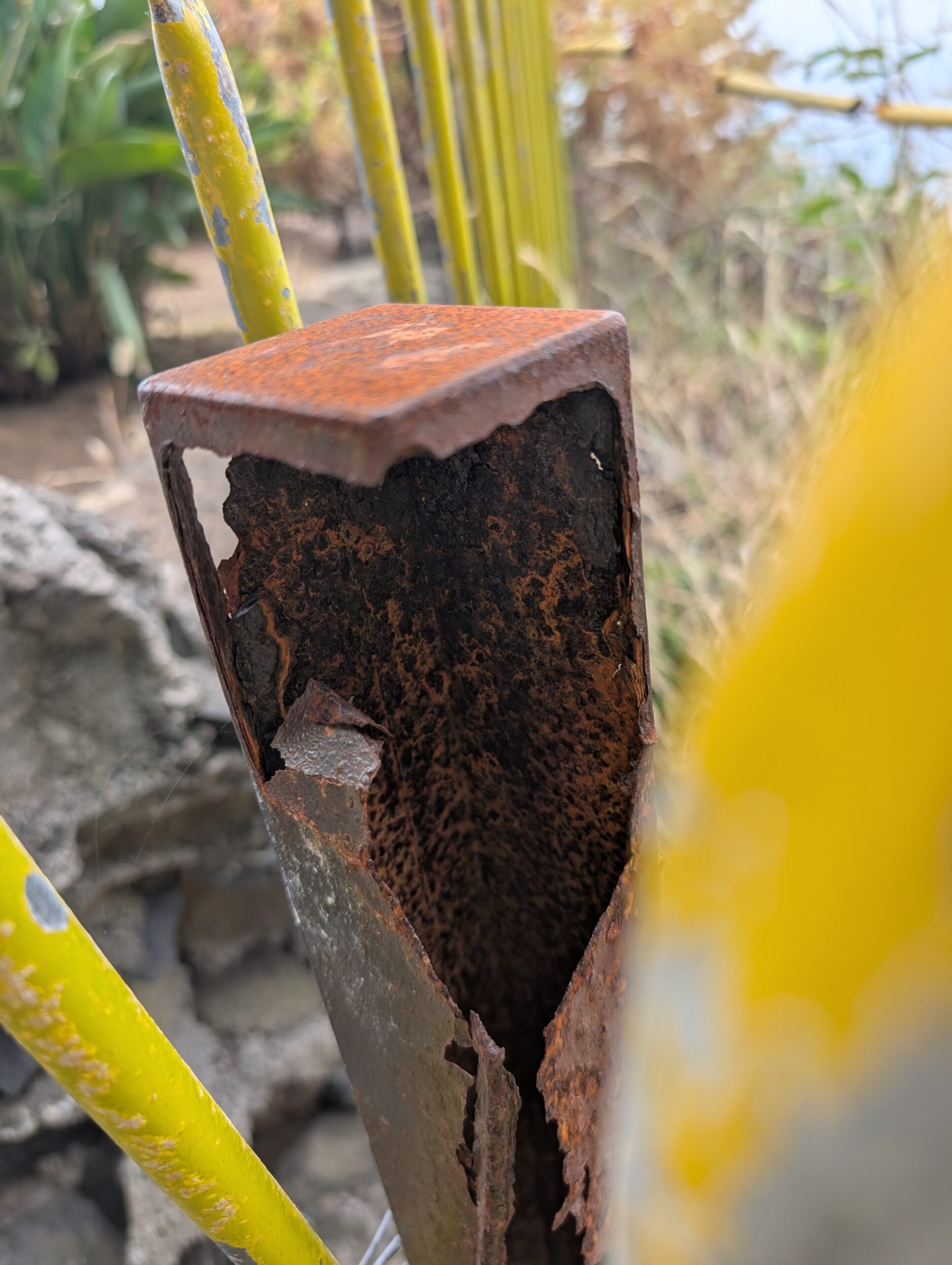 Hollow carbon steel square tube post corroded from the inside out, Madeira Portugal