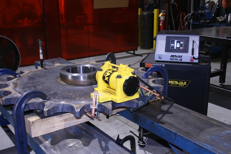 Meta-Lax vibratory stress relief unit clamped to a large sprocket weldment